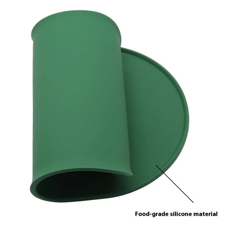 Silicone waterproof cat feeding placemat in green, shown under a food bowl.