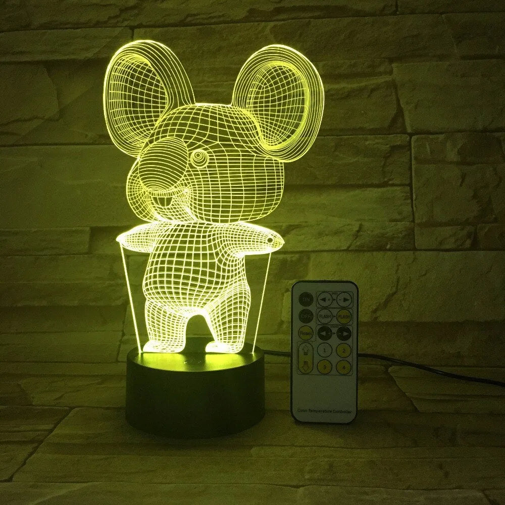 Black koala-shaped LED night light with remote control on a white surface