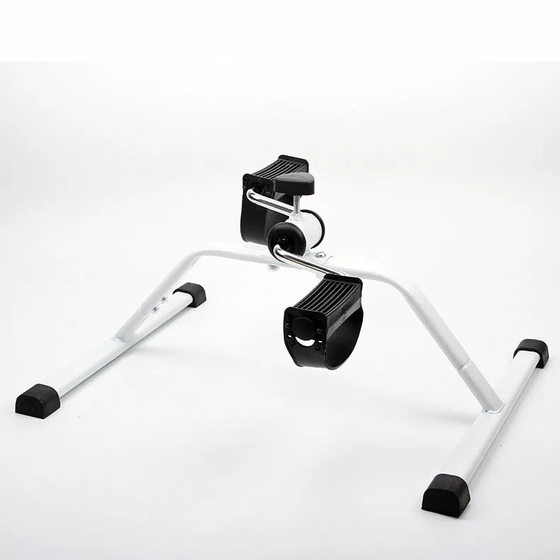 White mini exercise bike with mechanical resistance, non-slip pedals, rubber feet and 150kg maximum load