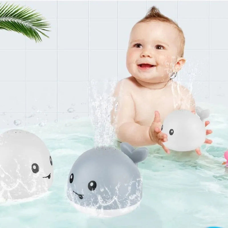 Whale-shaped bath toy with water spray feature and LED lights for baby bath time sensory play