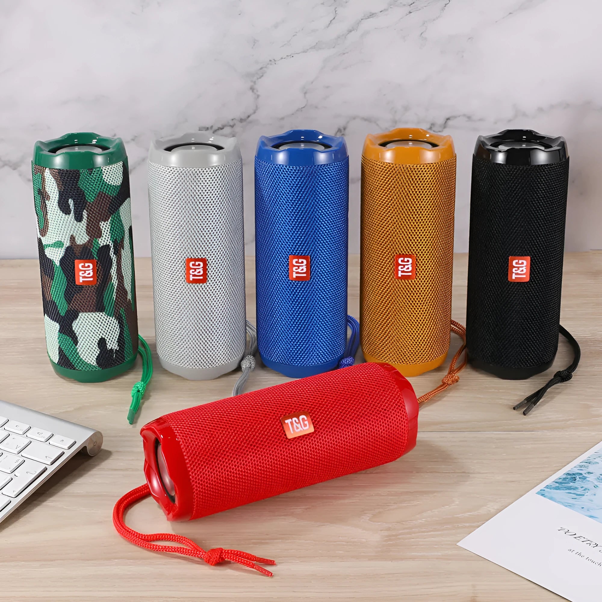 Portable fabric Bluetooth speaker with integrated card holder pocket on side, shown in available colours.