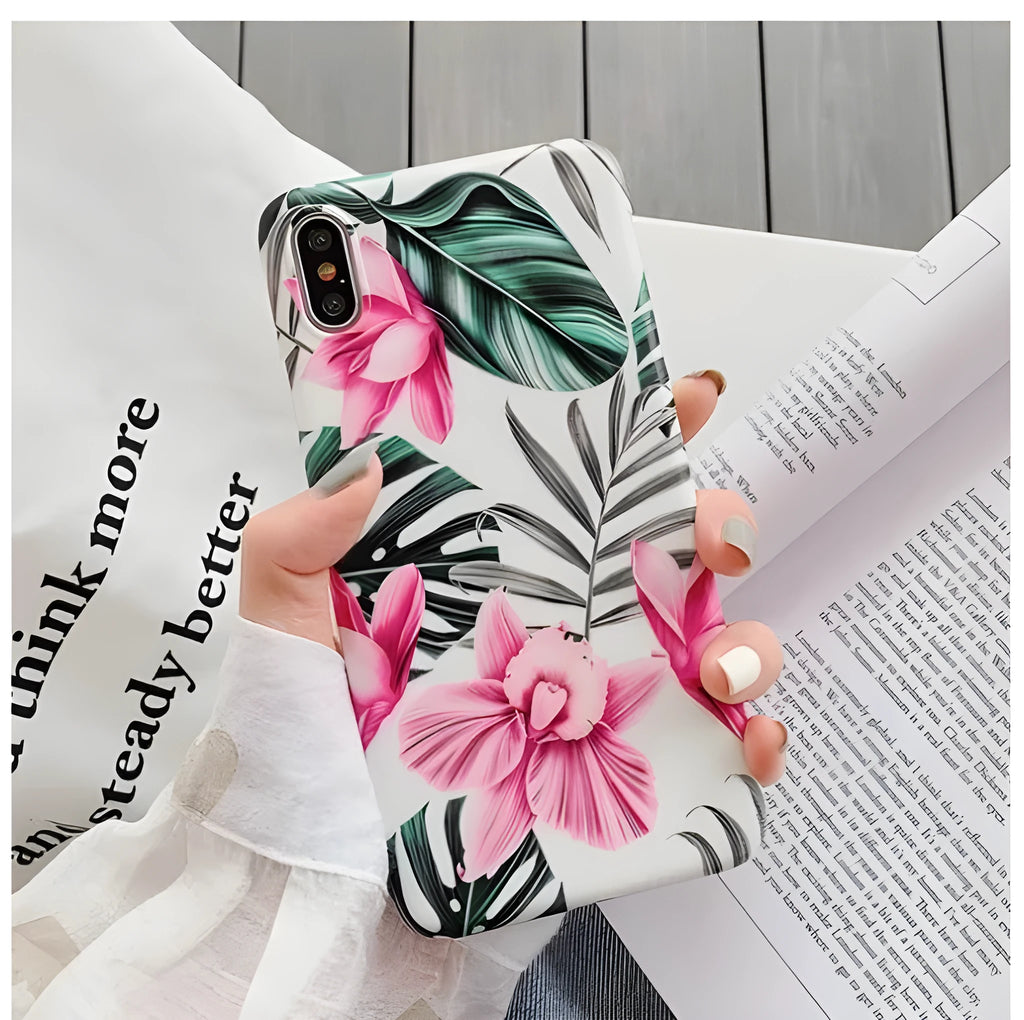 Pink floral pattern TPU back cover case for iPhone on a table.