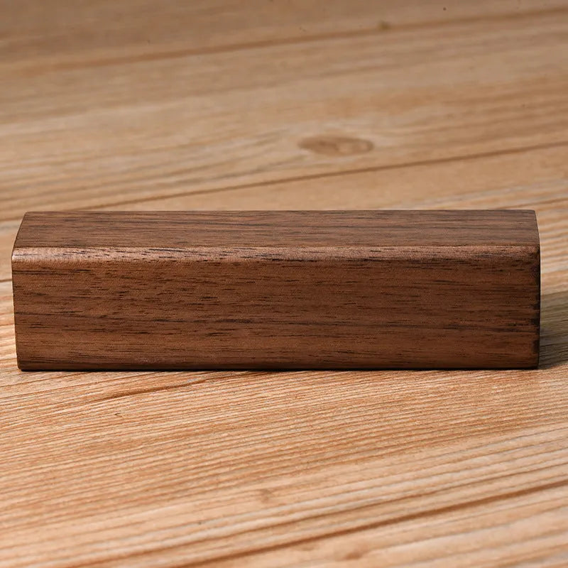 Brown walnut wood portable power bank with USB port showing compact rectangular design.