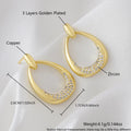 Yellow gold geometric drop earrings with round and oval ring elements on white background