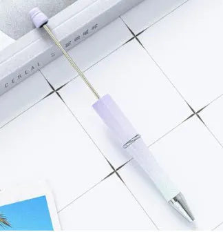 Ballpoint pen with colourful spinning plastic beads on barrel, shown in a gradient purple finish.