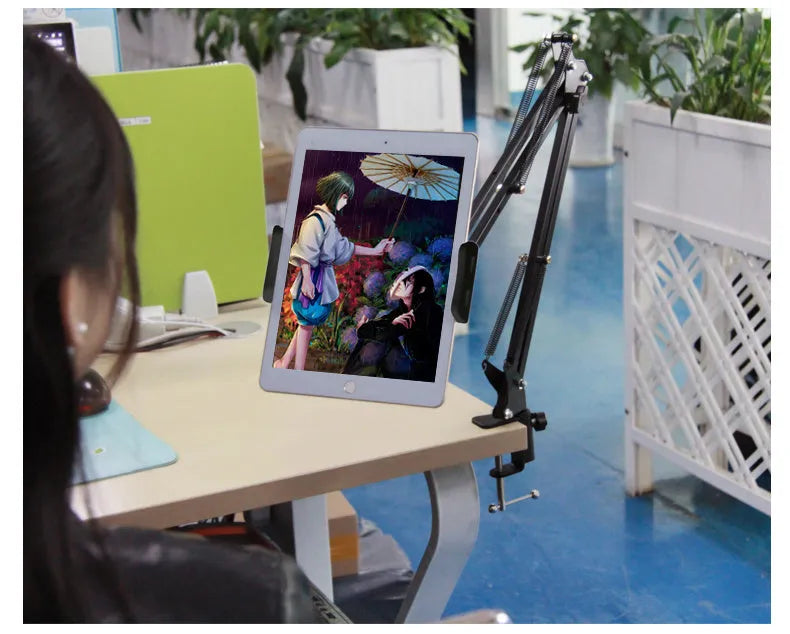 Black and white adjustable phone and tablet stand on a flat surface