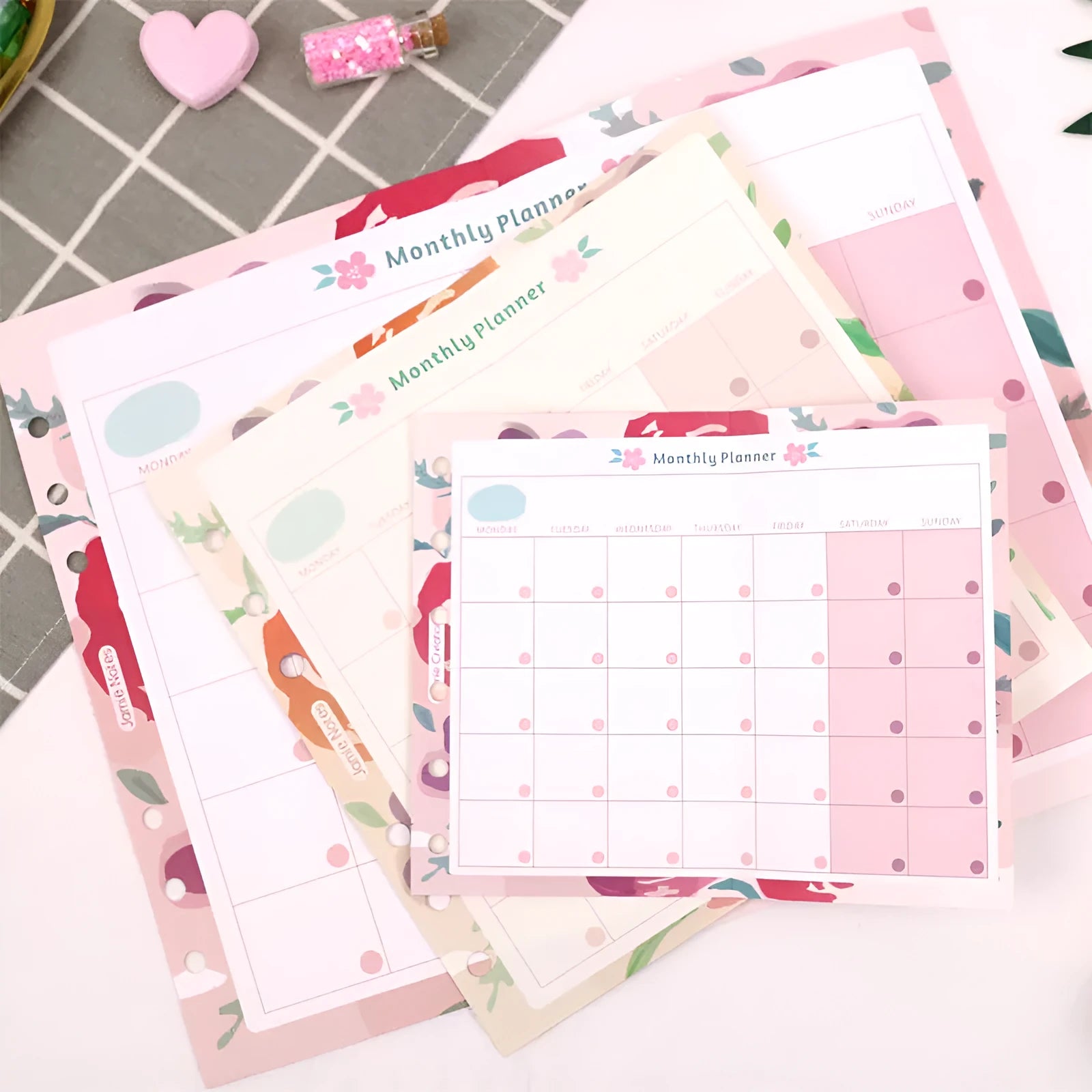 Handbook loose-leaf refill showing A7 floral monthly plan and A5/A6 tri-fold scheduler designs for organisers