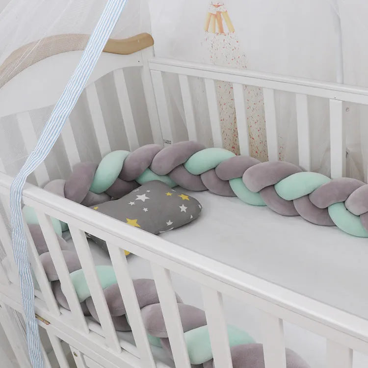 Braided knot design baby crib bumper in spandex velvet, shown in a light grey colour.