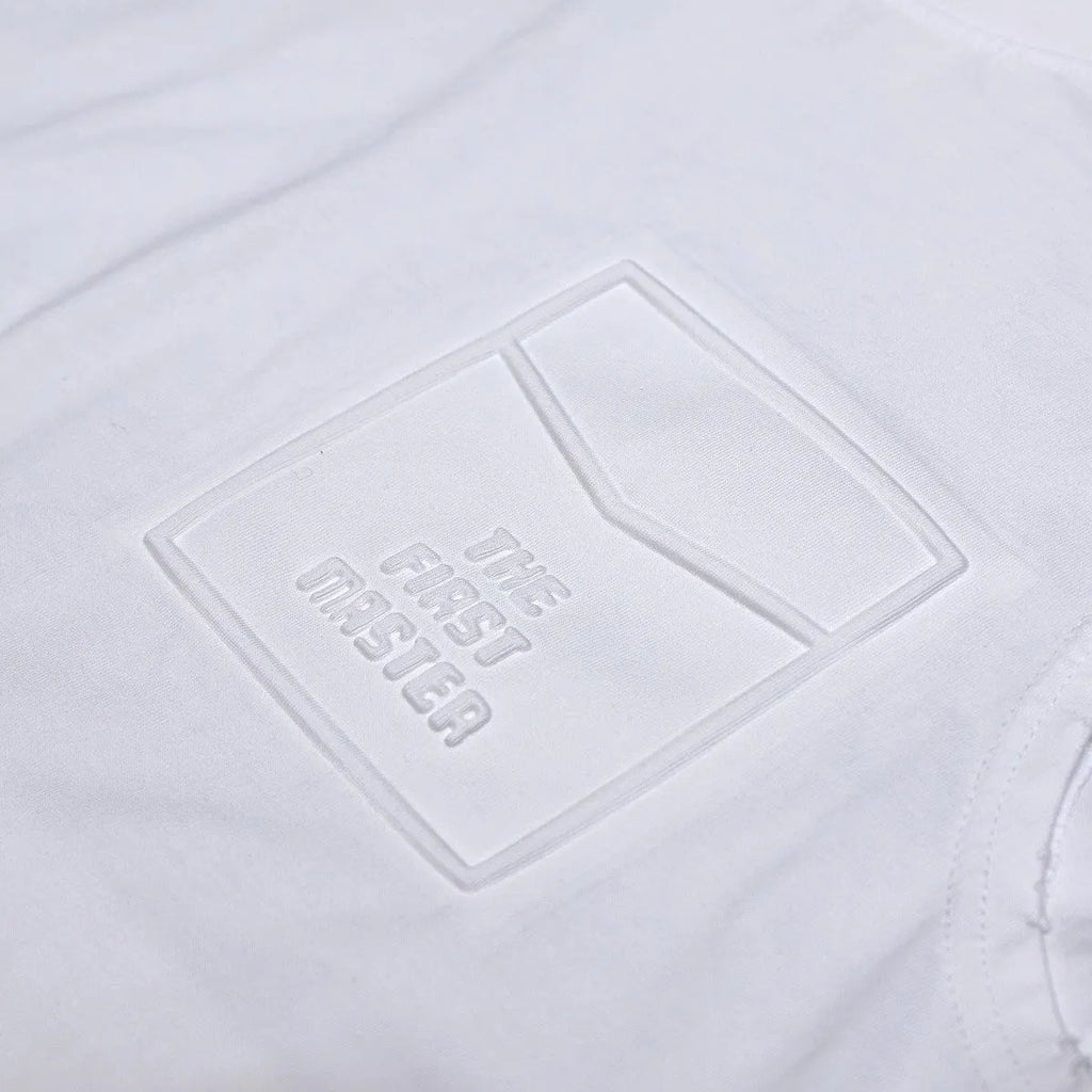 Loose fit cotton sleeveless t-shirt in black on a hanger, showing straight hem design.