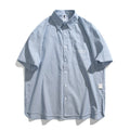 Blue striped short-sleeved shirt cardigan with a loose fit on a hanger.