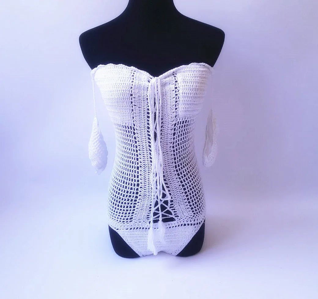 Women's off-shoulder one-piece swimsuit in light pink on a mannequin.
