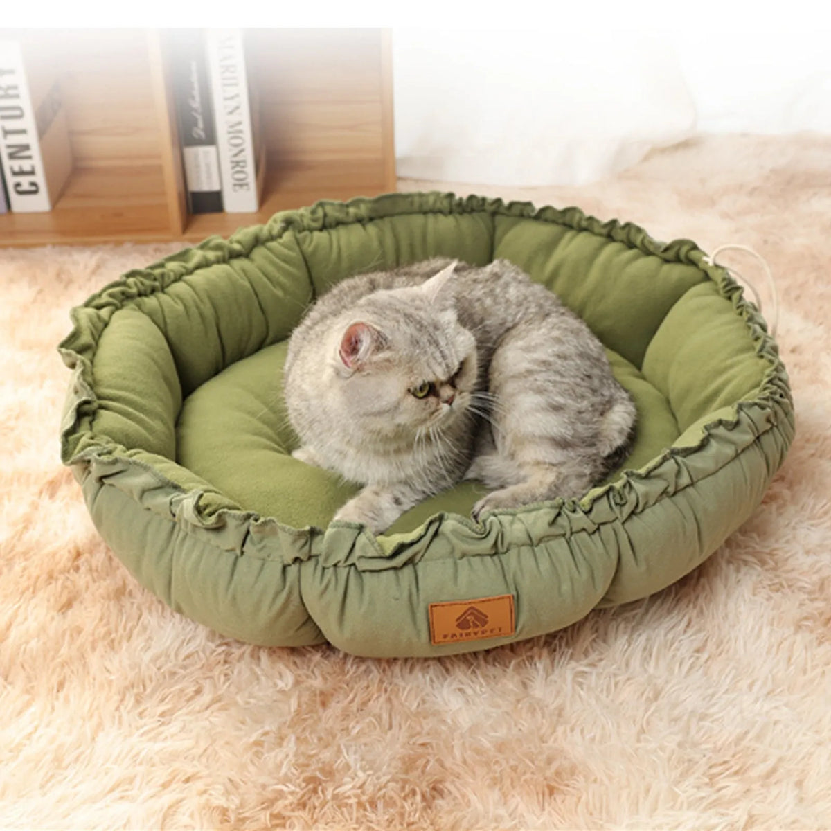 Grey reversible donut-shaped pet bed for cats and small dogs on a floor.