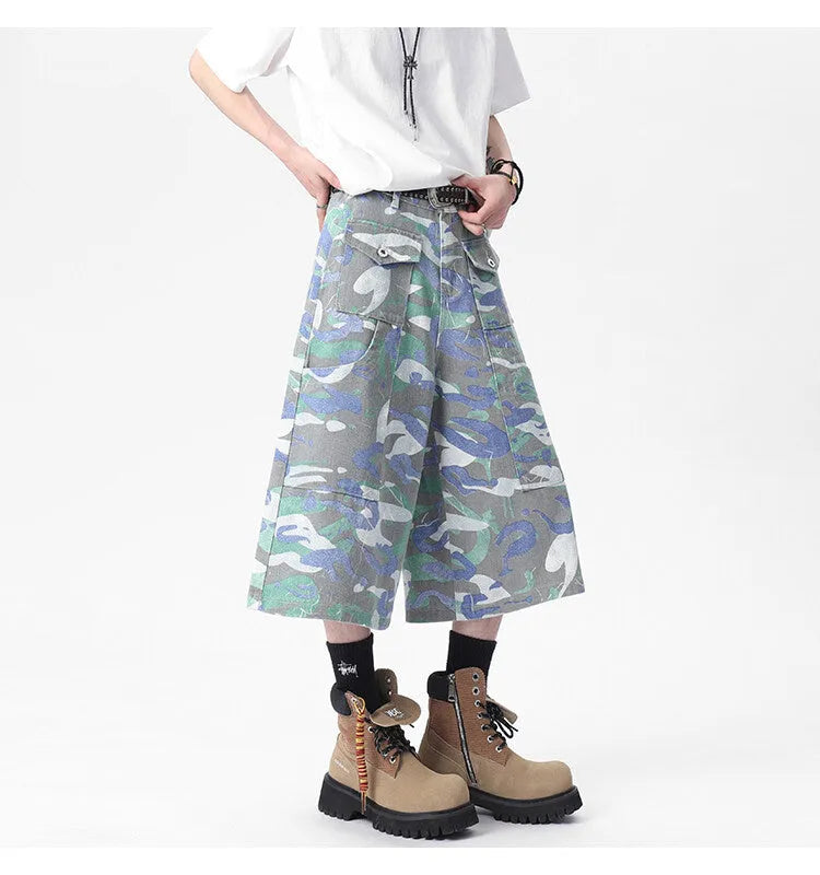 Men's camouflage colour denim cropped cargo trousers on a plain background