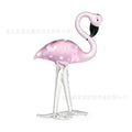 Pink and white crystal decorative flamingo table prop on a modern shelf