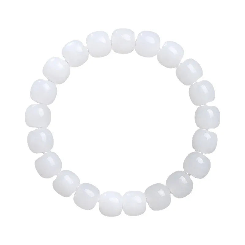 White Hetian jade barrel bead bracelet for men and women on a wrist.