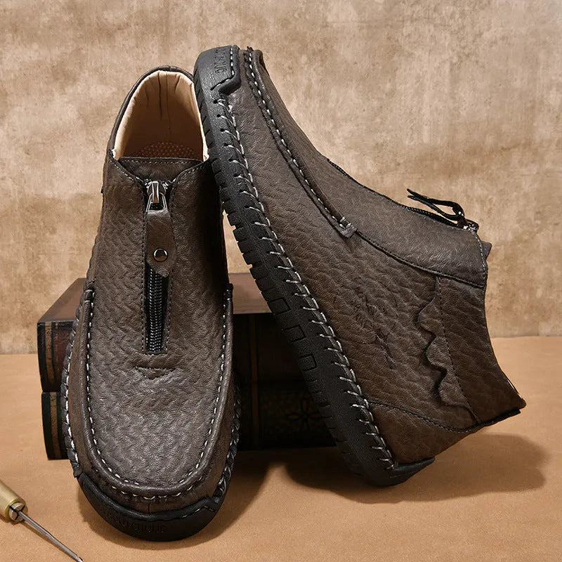 Men's black slip-on loafers with a round toe and rubber sole, shown in a casual style.