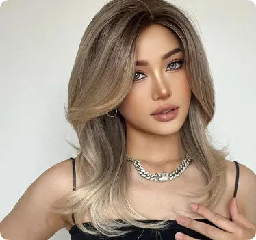 Mid-length platinum gradient curly wig with long bangs on a display stand