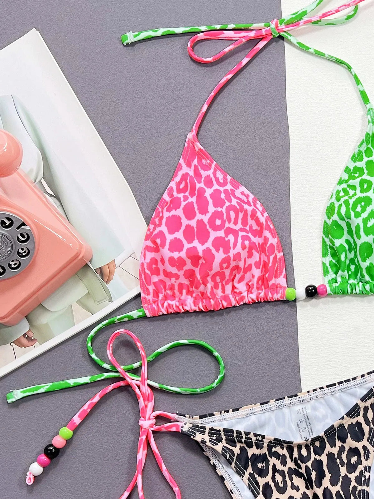 Women's leopard print bikini swimsuit with matching bra and briefs on size chart background