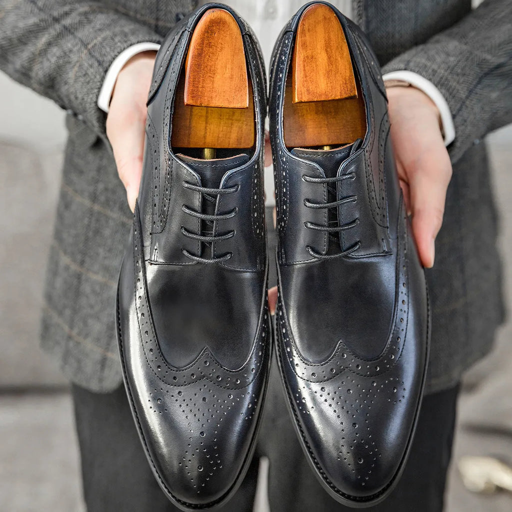 Men's burgundy pointed toe formal shoes with carved brogue patterns and lacing closure