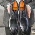 Men's burgundy pointed toe formal shoes with carved brogue patterns and lacing closure