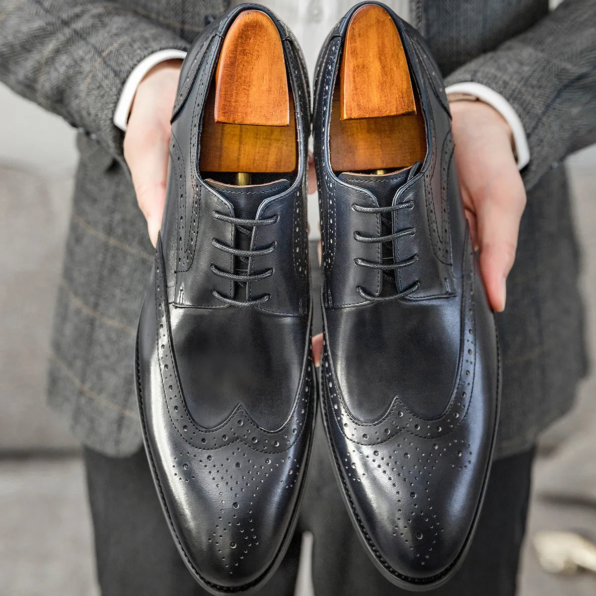 Men's burgundy pointed toe formal shoes with carved brogue patterns and lacing closure