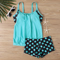 Women's black polka dot high waist swimsuit briefs on a white background.