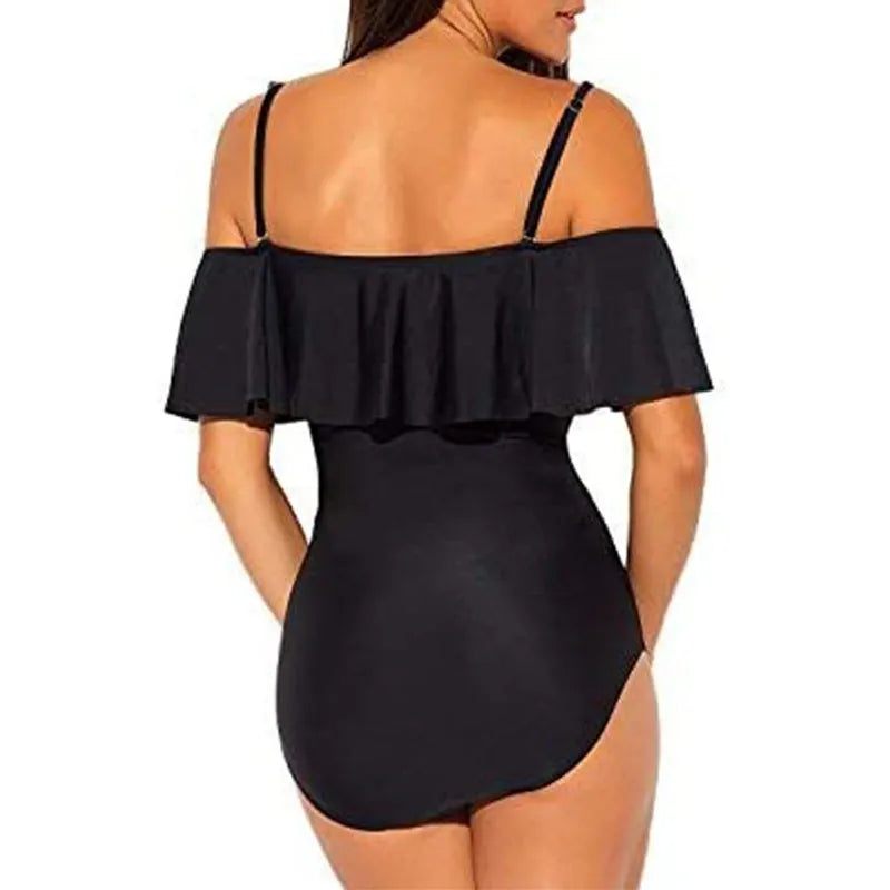 Black one-piece swimsuit with cut-out sides and ruffled shoulder straps on a mannequin.