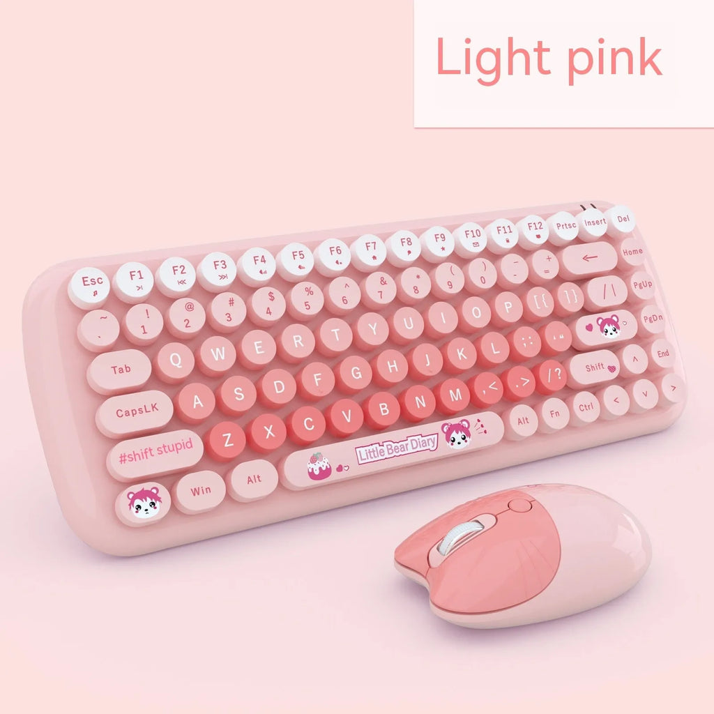 Compact pink wireless keyboard and mouse set with USB receiver on a desk