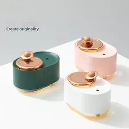 Green rotating planet USB humidifier with night light on wooden desk
