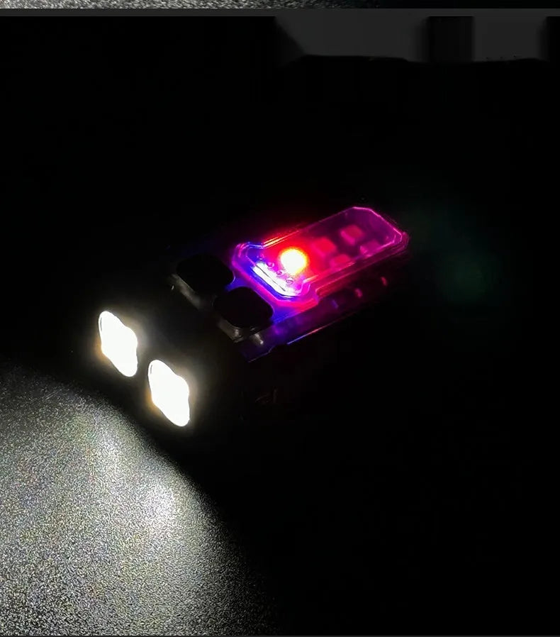 Compact USB rechargeable tactical flashlight with a black mounting clip attached to a backpack strap.