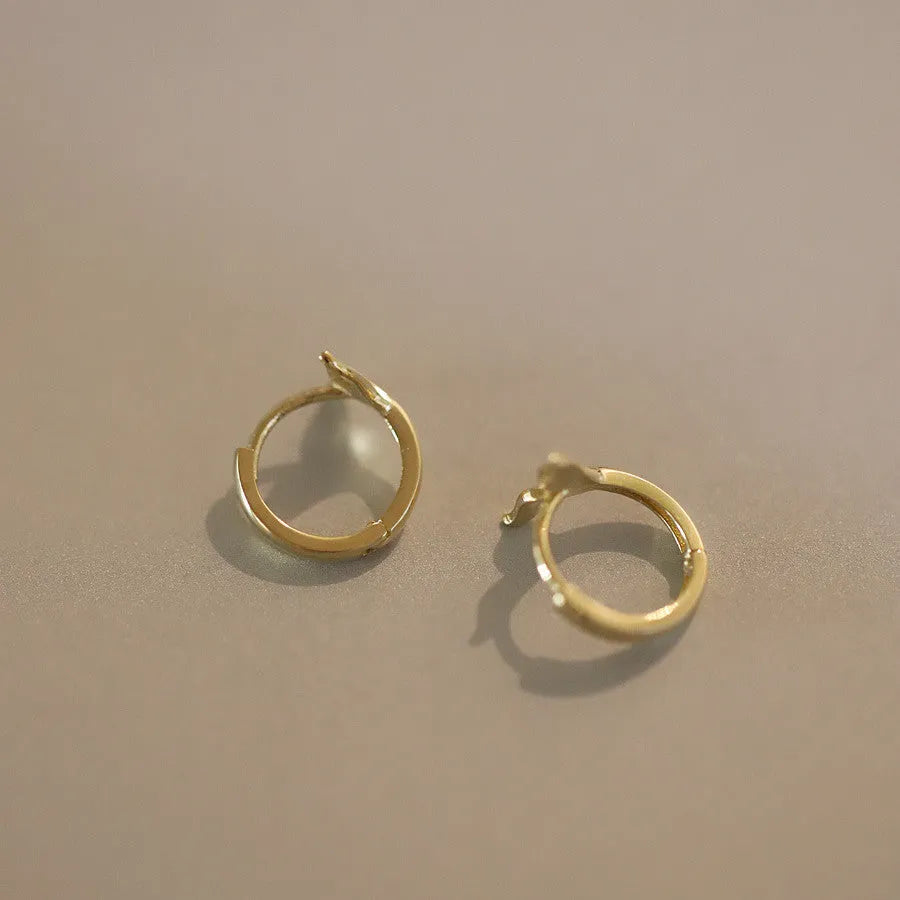 Pair of S925 sterling silver earrings with 14k gold plating featuring a smooth fishtail design and 8mm inner diameter