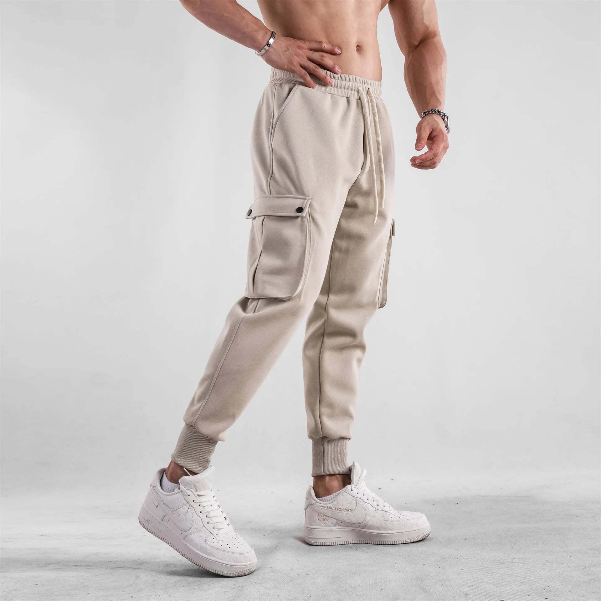 Men's loose cotton sports trousers with ankle tie closure and multiple pockets in solid colour