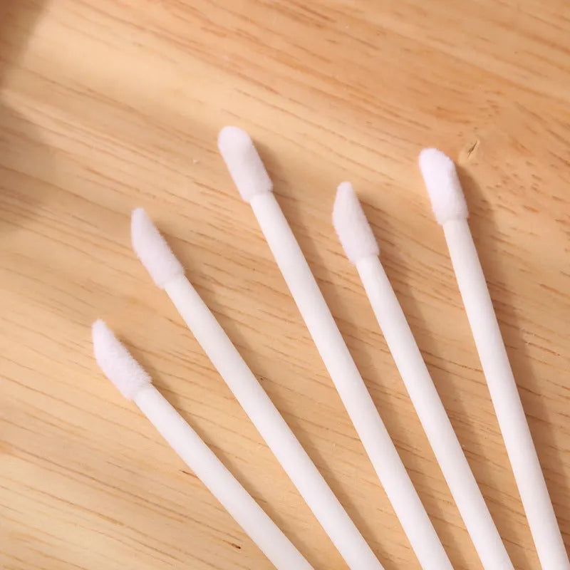 Pack of multi-colour disposable lip brush applicators with black handles and soft flocked tips.