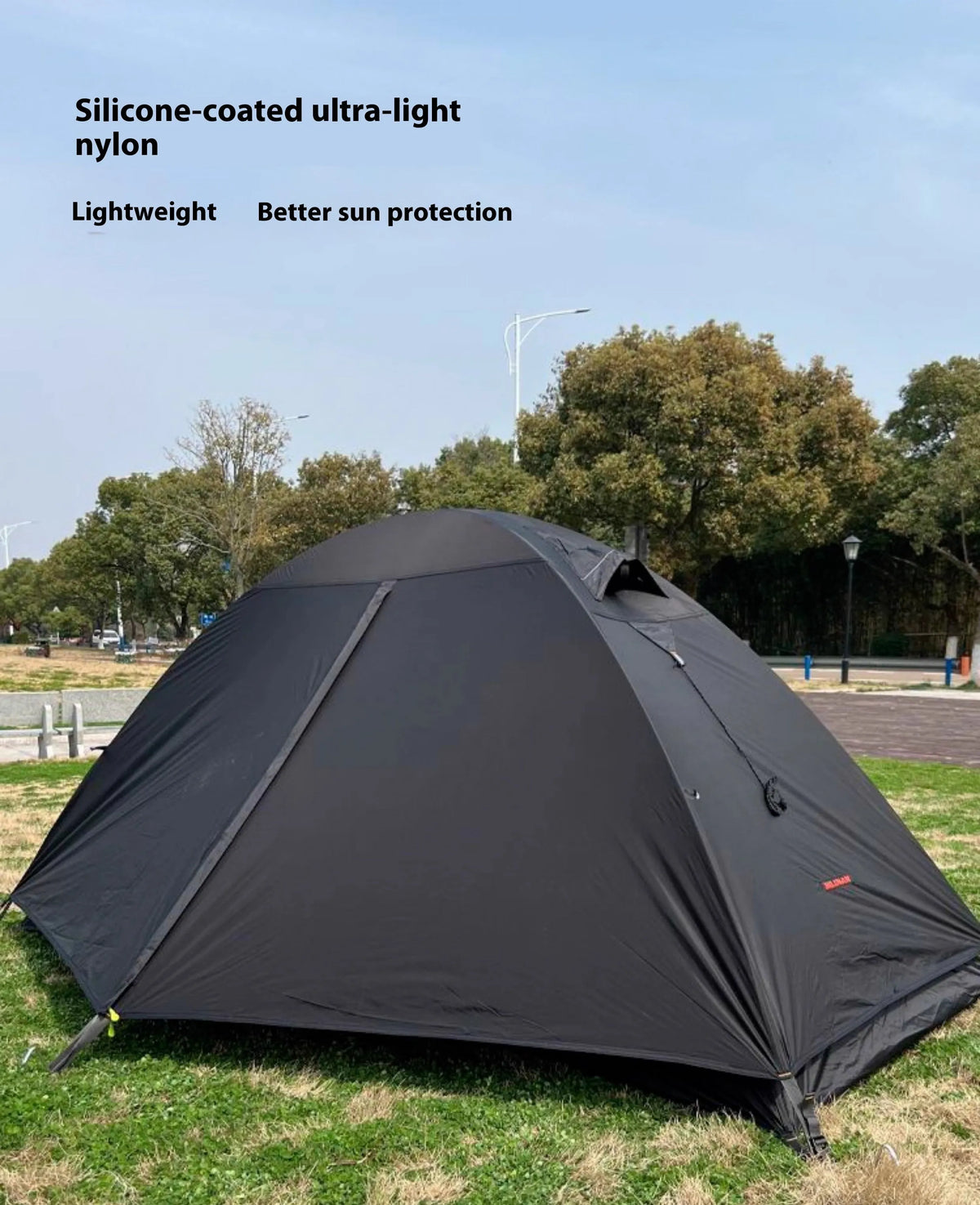 Single person hiking tent with aluminium poles in red colour, shown fully pitched with ventilation mesh visible.