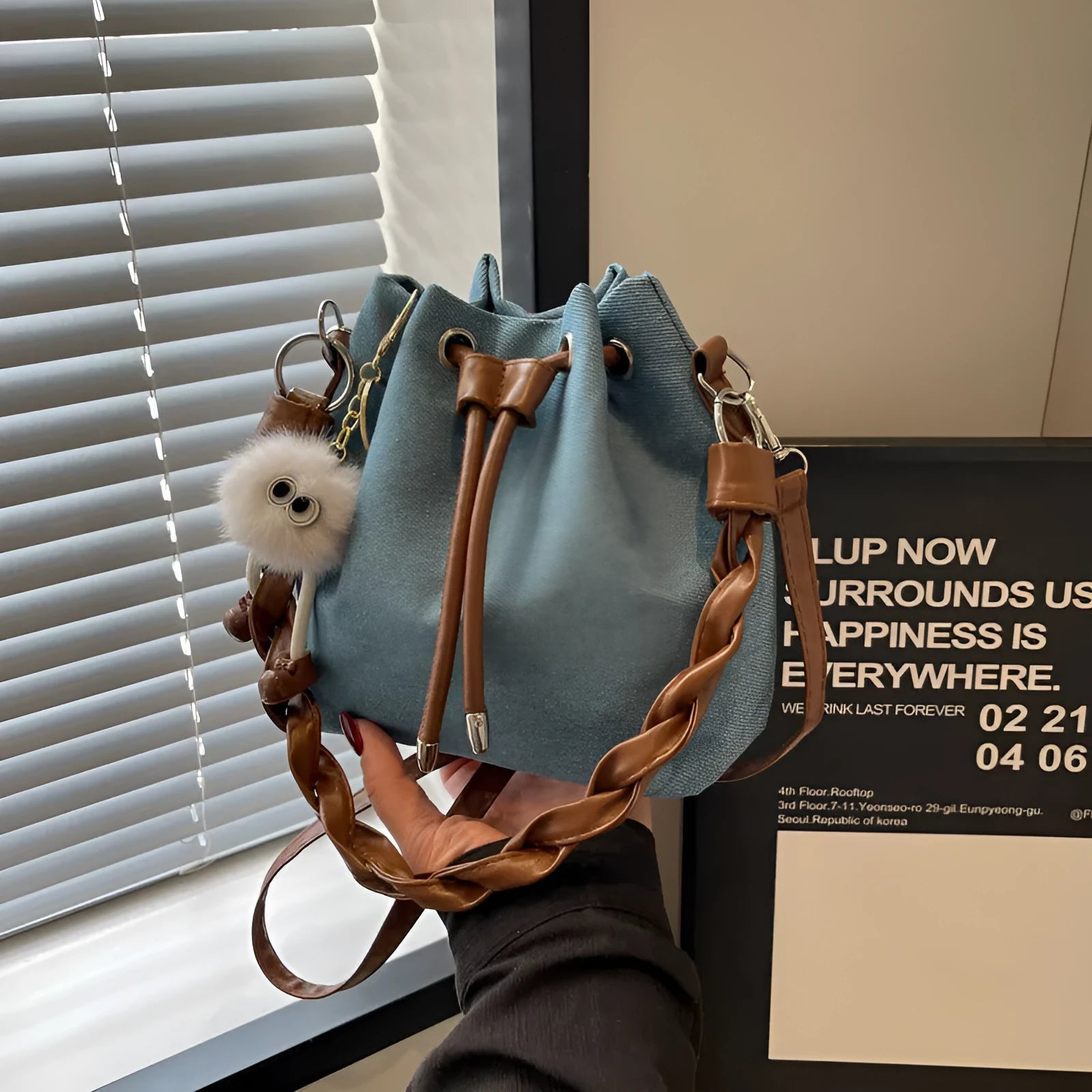 Blue synthetic leather one-shoulder cross body bucket bag with optional hanging ornaments