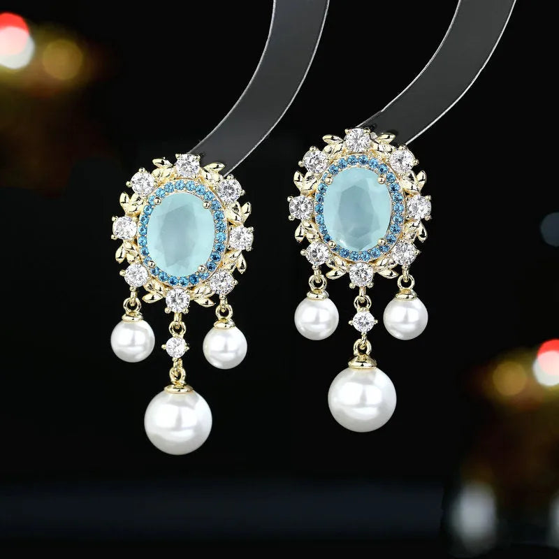 Oval geometric earrings with zircon inlay and tassel detailing in light purple, pink, and white colour options