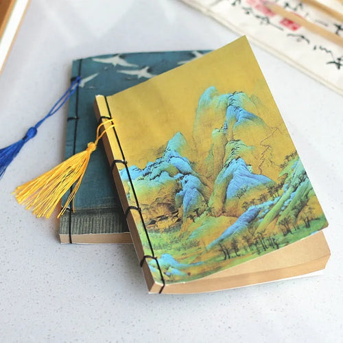 A5 antique wire-bound notebook with glossy embossed cover featuring a retro painting design, shown open.