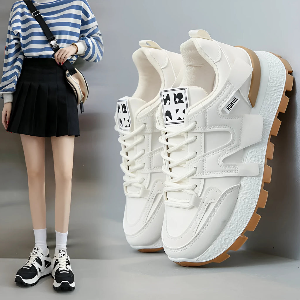 Low-top white running sneakers with round toe and front lace-up design on rubber sole