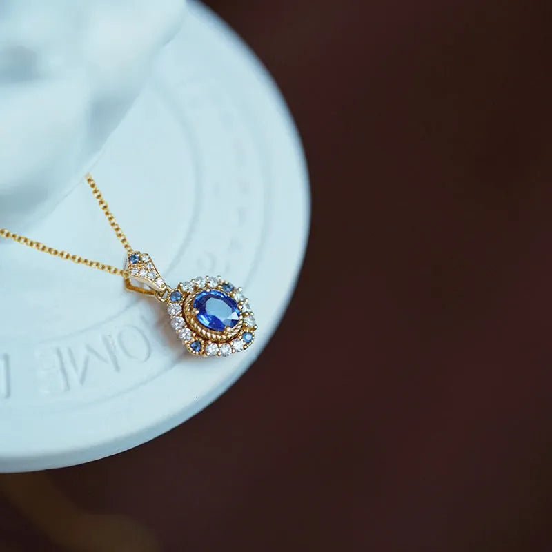 Yellow gold mixed gem pendant necklace with inlaid zircon stones on a box chain.