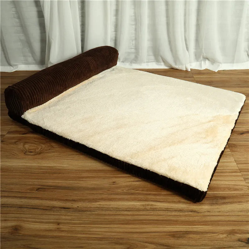 Corduroy pet sofa dog bed with a raised bolster, shown in a grey colour on a wooden floor.