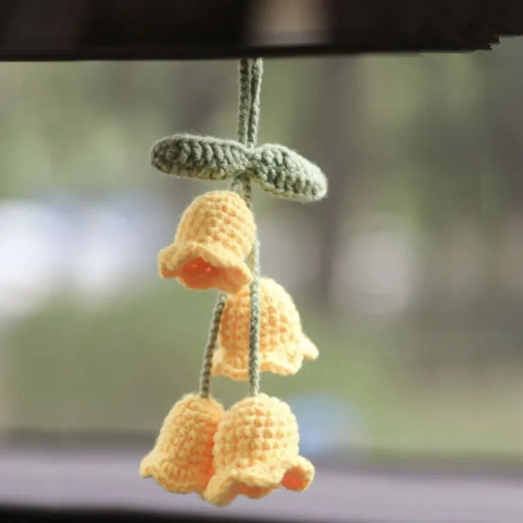 Green and white knitted wool car plant decoration with plastic base and hanging rope