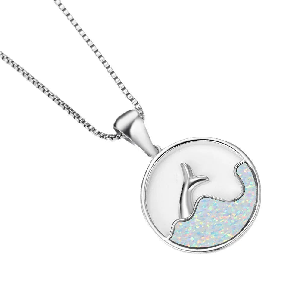 White gold colour electroplated necklace with a round sea fishtail pendant featuring a blue opal stone.