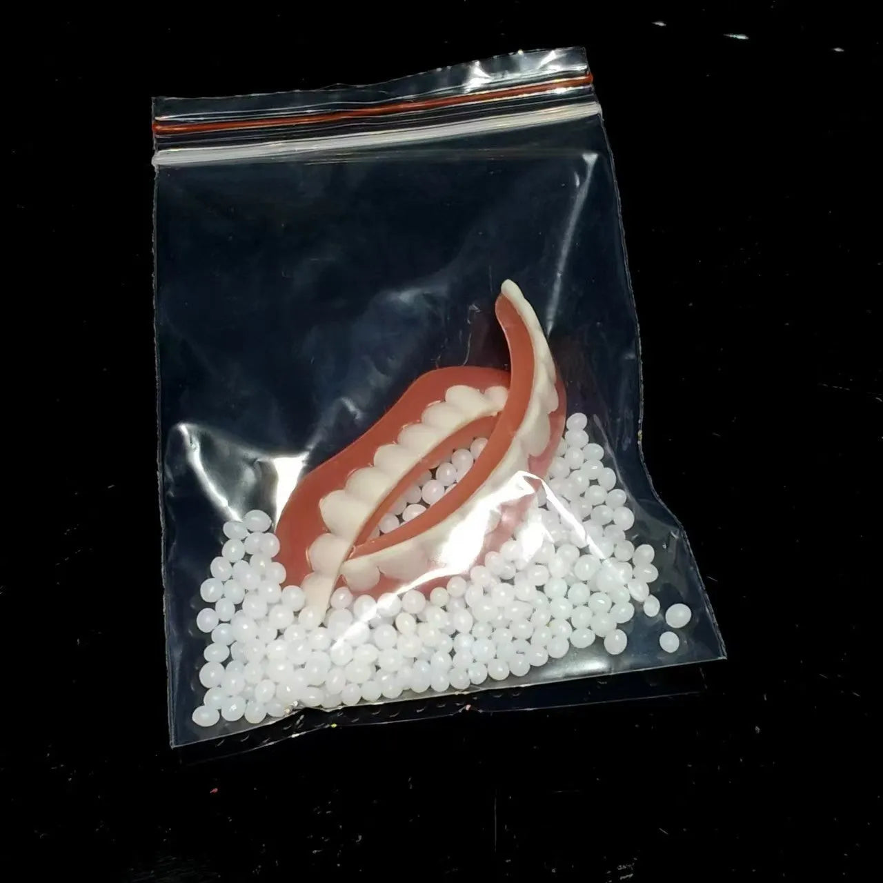Silicone simulation dentures showing upper and lower teeth configuration in colour-coded box