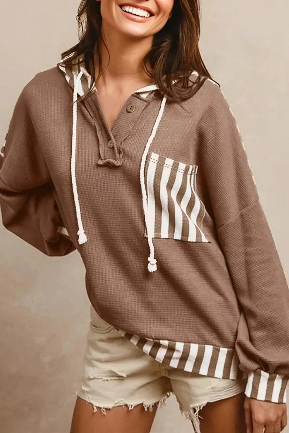 Straw yellow waffle texture hoodie with striped patchwork design, button neck, and drawstring hood.