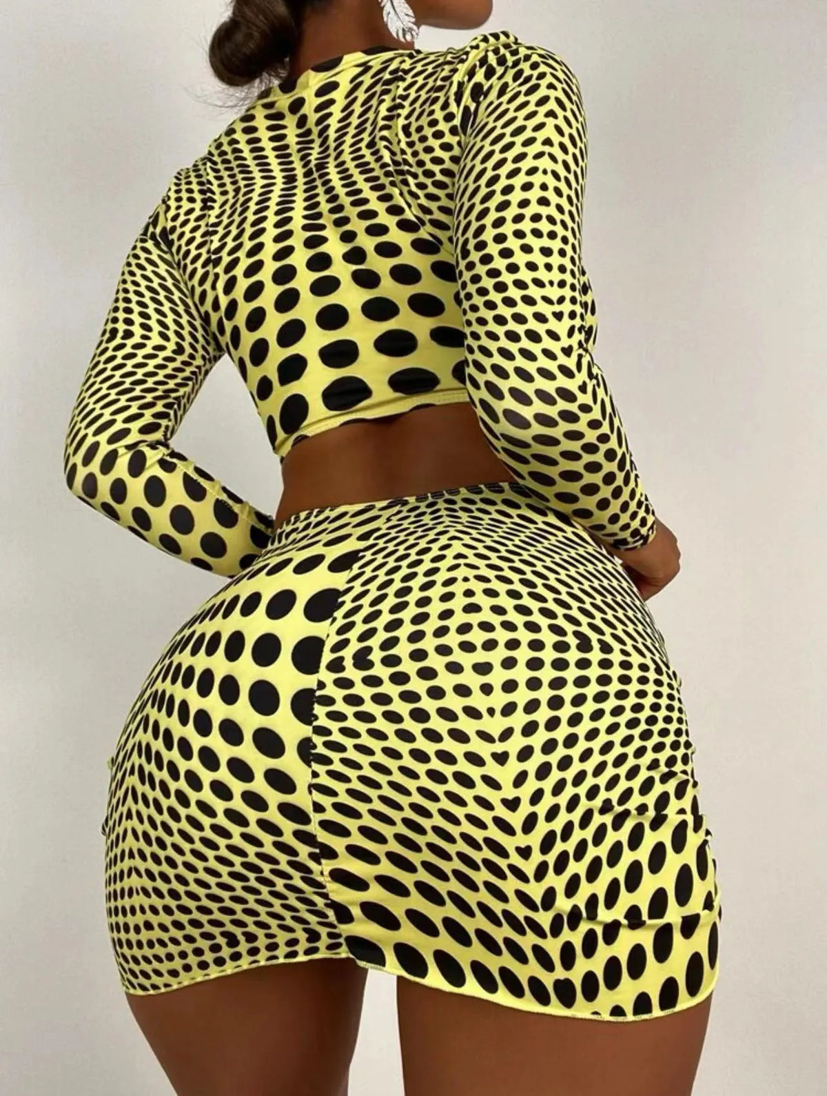 Women's green polka dot three-piece swimsuit set with halterneck bikini top and matching skirt