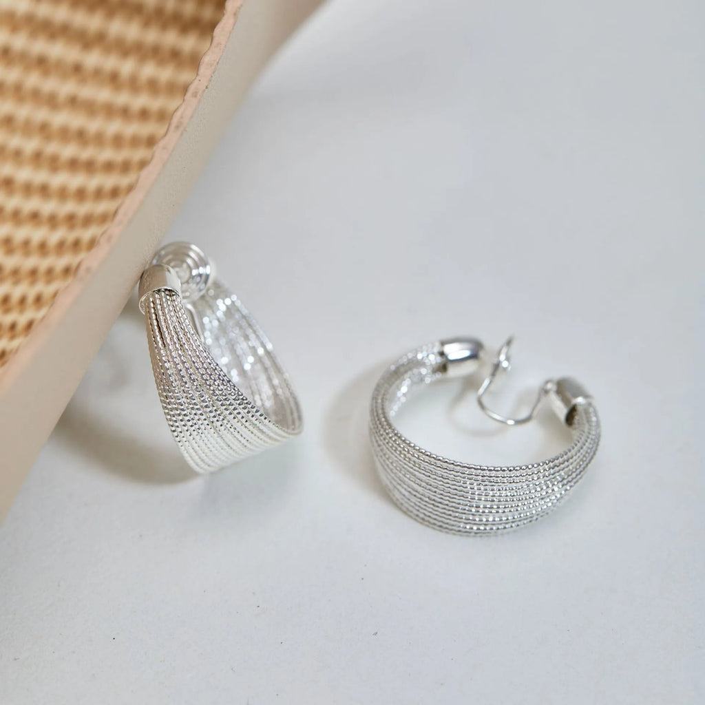 Geometric copper earrings in silver and gold finishes as clip-on and stud styles