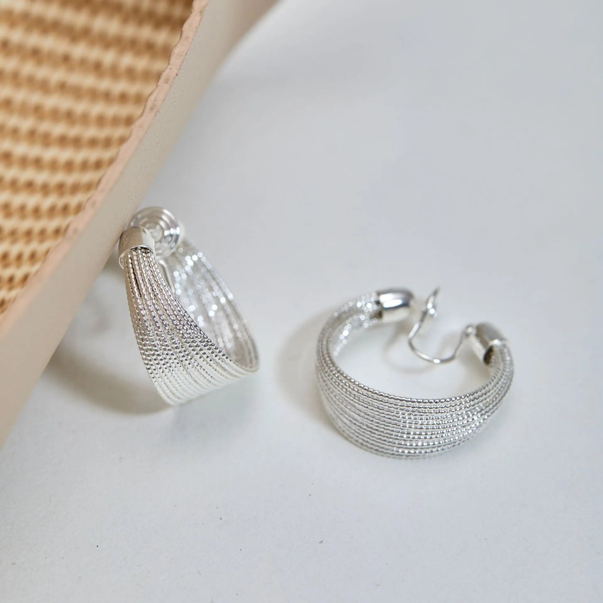 Geometric copper earrings in silver and gold finishes as clip-on and stud styles