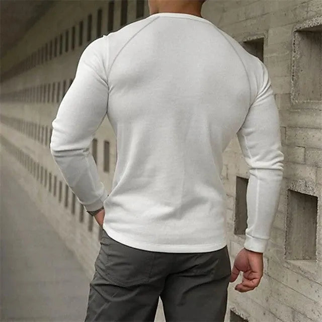 Men's white long-sleeved t-shirt with a Henry collar, laying flat.