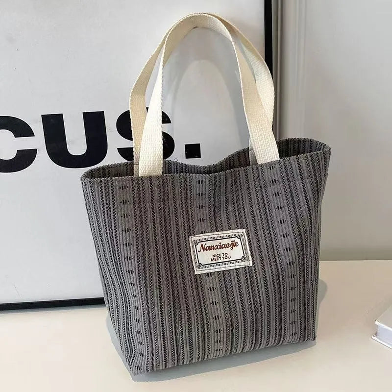 Japanese style corduroy shoulder bag in dark brown colour showing textured fabric and large main compartment