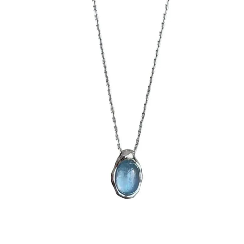 Navy blue and white gold geometric water drop pendant necklace on a cross chain for women.